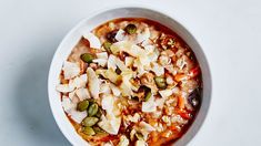 a white bowl filled with food on top of a table