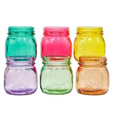 four different colored mason jars sitting side by side