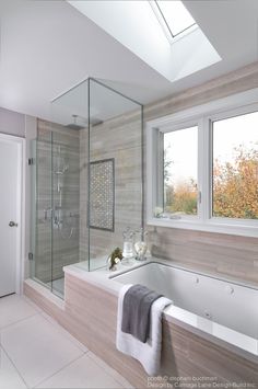 a bath room with a tub a sink and a window on the side of it