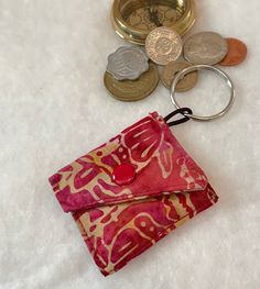 a purse with coins and a keychain on it