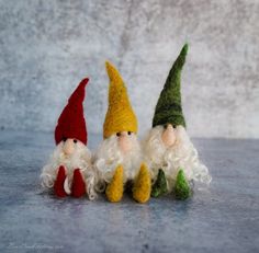 three small gnomes sitting next to each other