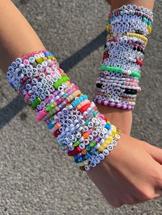 two hands are holding bracelets made out of letters and numbers that spell out the word love