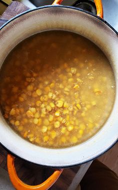 a pot filled with soup sitting on top of a stove