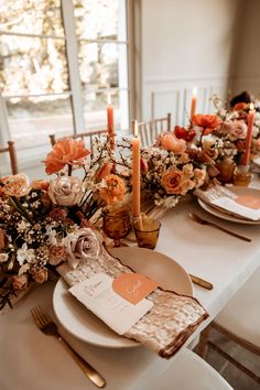 the table is set with flowers and candles for an elegant dinner party or wedding reception