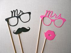 two cake toppers with mustaches, glasses and lips on sticks in the shape of mr and mrs