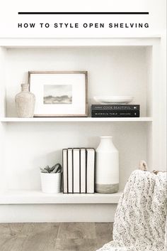 a white shelf filled with books and vases