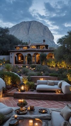 an outdoor living area is lit up with candles