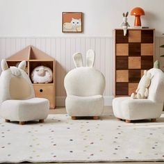 three children's chairs in various shapes and sizes, one with a stuffed animal on it