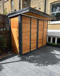 a small wooden building sitting in the middle of a yard