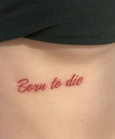 a woman's stomach with the word born to die written in red ink on it