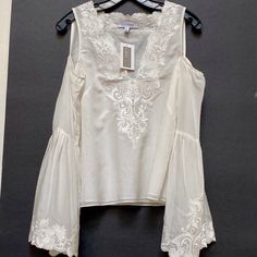 Nwt Intermix Cold Shoulder V-Neck Embroidered Blouse Sz S . Est. Retail $265.00 Exquisite Beautiful Fabric And Embroideries ! Very Classy And Feminine Cut Out Shoulder ! Bust: 35" Waist: 35" Length: 22.25" Fabric: 70% Cotton, 30% Silk; Lining 70% Cotton, 30% Silk; Embellishment 100% Polyester Condition : New With Tag, Prestine Final Sale , No Return Elegant Summer Embroidered Top With Sleeves, Elegant Summer Top With Embroidered Sleeves, Elegant Embroidered Top With Sleeves For Summer, Elegant Summer Blouse With Embroidered Sleeves, Chic White V-neck Embroidered Top, Elegant V-neck Top With Embroidered Neckline, Summer V-neck Blouse With Embroidered Sleeves, Chic Fitted V-neck Embroidered Top, Fitted V-neck Tops With Embroidered Neckline