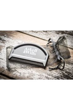 an image of a comb and scissors on a wooden table with the words artful style