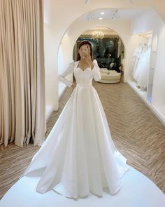 a woman is taking a selfie in her wedding dress