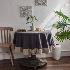 a table with two chairs and a potted plant