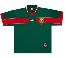 a green and red soccer jersey with an emblem on the chest