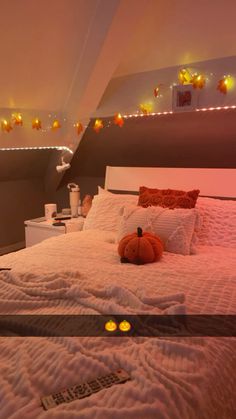 a bed that has some lights on the headboard and pillows in it with a stuffed animal