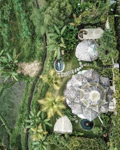 an aerial view of a garden with tables and umbrellas in the middle of it