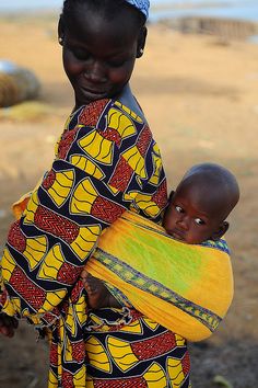 a woman holding a baby in her arms