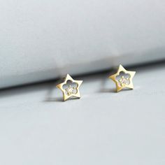 "* Small Gold Star Studs with crystal  * Gold Plated on 925 sterling silver * No Nicole * Single Star * Small Silver Studs * Approx 1/4\" W x 1/4\"H * Post is 3/8\" long * White ( Clear) Crystal * 1 order = 1 pair ( 2 pcs) * Gift For her This is a PAIR super cute Gold star stud earrings. Plated on sterling Silver. Minimalist. Cute cut out star earrings. Feminine star studs with a touch of tiny white (clear) crystal.  AAA grade Cubic Zirconia crystal. 925S stamp on the post. Post is regular size, fits most of the ear lop comfortably.  Simple, Girly, Minimal. Match with all types wear. Everyday wear or some special occasions.  It matches easily with causal T-shirt and diem bottoms. It will brighten up the face with a cute summer dress. It will also be the touch of light for a little cocktail Tiny Gold Studs, Stud Earrings Women, Gold Star Earrings, Luxury Party, Star Stud Earrings, Tiny Star, Star Earrings Stud, Crystal Light, Crystal Stars