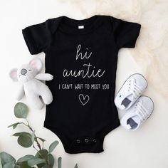 a baby's bodysuit with the word finally and two feet on it next to a teddy bear