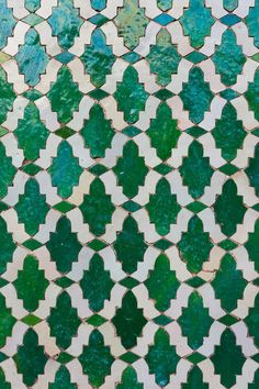 an intricate green and white tile pattern