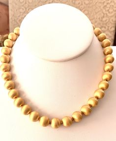 Vintage Vendome brushed gold tone beaded necklace.  Main beads measure 10mm each.  Necklace measures 17 inches long including extension.  Hook and beaded extension.  Large beads are strung on chain with tiny spacers in between.  Marked on back of hook, VENDOME.  Excellent condition. Gold Beaded Necklace, Large Beads, Trifari Jewelry, Gold Bead Necklace, Vintage Cufflinks, Solid Perfume, White Necklace, Beaded Choker Necklace, Necklace Vintage