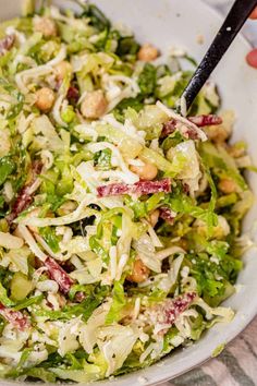 a white bowl filled with salad on top of a table