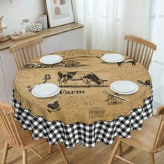 a dining room table covered with a black and white checkered tablecloth that has farm animals on it