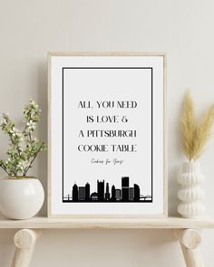 a black and white poster with the words all you need is love and a pittsburgh cookie table