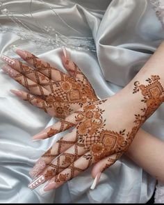 a woman's hands with hennap on top of her arm and hand