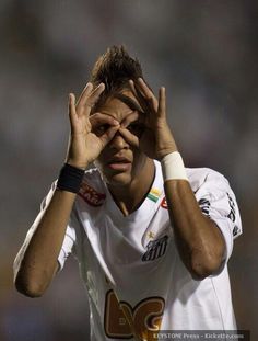 a soccer player holding his hands to his face