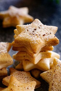 star shaped cookies are stacked on top of each other with cinnamon sprinkles