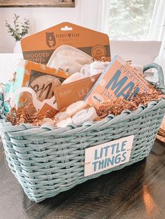 a basket filled with books on top of a wooden table