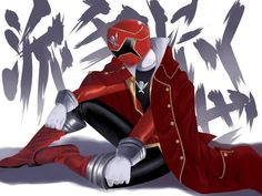 a person in a red suit and mask sitting on the ground with their legs crossed