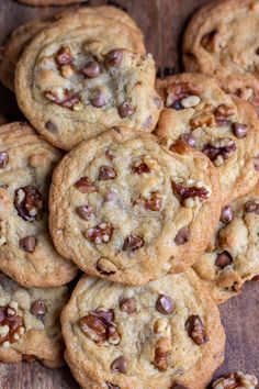 chocolate chip cookies with walnuts and pecans on a wooden surface, ready to be eaten