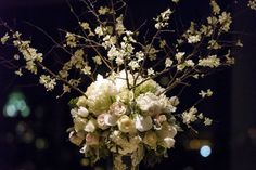 a vase filled with white flowers on top of a table