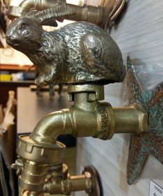 an antique brass faucet with a ram head on it