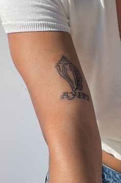 a person with a tattoo on their arm and the word love is written in black ink