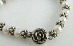 "Here is a great sterling silver link bracelet. The shine from the silver along with the pearl and floral design gives this bracelet amazing eye appeal. A great piece that is sure to be noticed and admired. Metal: Sterling Silver Stamped: 925 Bracelet Wrist Size: 7\" Width: 8.5mm If you have any questions on this item, please message us! GandDJewelers.etsy.com Please note that all of our pieces have been analyzed & identified by a Gemological Institute of America Certified Specialist. Additi Floral Cuff, Bracelet Wrist, Silver Link Bracelet, The Pearl, Silver Pearls, Cool Eyes, Chain Link Bracelet, Link Bracelets, Pandora Charm Bracelet