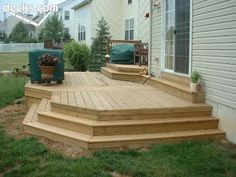 a wooden deck with steps leading up to it