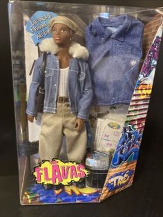 a barbie doll in a box with clothes on the back and an image of a man's jacket