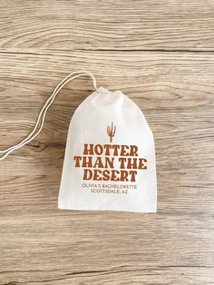 a white bag with the words hotter than the desert on it