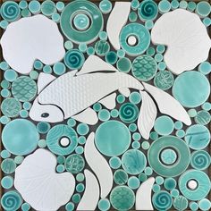 this is an image of a fish made out of sea glass mosaics and pebbles