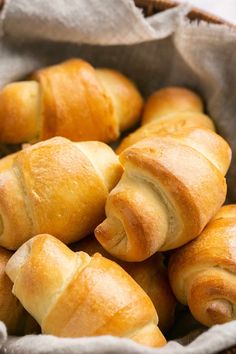 a basket filled with croissants sitting on top of a table