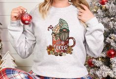 Hot Cocoa Gnome Sweatshirt, Hot Cocoa Gnome Sweater, Cute Gnome Sweatshirt, Christmas Hot Cocoa Hoodie, Funny Christmas Sweater Gift Shirt  ORDER INSTRUCTIONS  ➤ Check and review all listing photos. ➤ Pick up your item's size and color from drop down menus. ➤ Choose the quantity. ➤ Click "Add to Cart" button. ➤ Fill in the personalization box as recommended if provided. ➤ You can go back to add more item or you can complete the checkout process. ➤ Click "Proceed to Check Out".  WHICH SIZE FITS ME BEST  ➤ In each listing, you can find pictures showing the variety of colors and body sizes. ➤ Measurements are in inches. ➤ With arms down at side, measure around the upper body, under arms and around the fullest part of the chest.  IMPORTANT  ➤ Due to the nature of the fabric as well as your mon Gnome Sweatshirt, Retro Pink Christmas, Pink Merry Christmas, Pink Christmas Trees, Christmas Hot Cocoa, Funny Christmas Sweater, Christmas Tree Sweater, Vintage Christmas Sweaters, Funny Christmas Sweaters