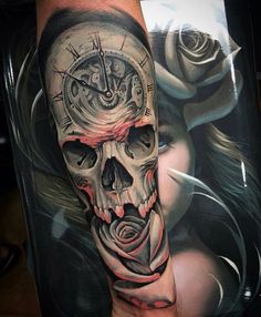 a man's arm with a skull and roses on it