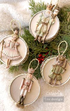 four christmas ornaments hanging from a tree