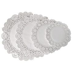 six white doily plates on a white background