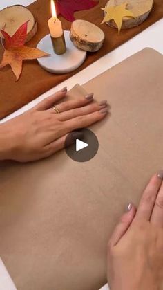 a woman is wrapping paper with her hands