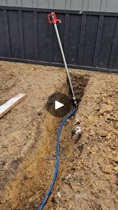 a blue hose is connected to a hole in the ground that has been dug into